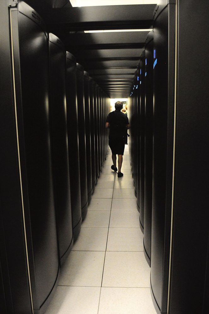 Interior of HI2000 micro-module data center showing server rack and cooling unit