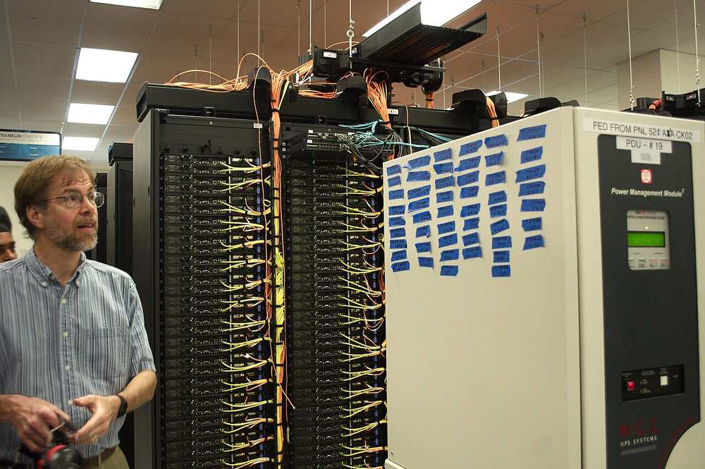 Pre-assembled UPS module being lifted into place in a data center hall